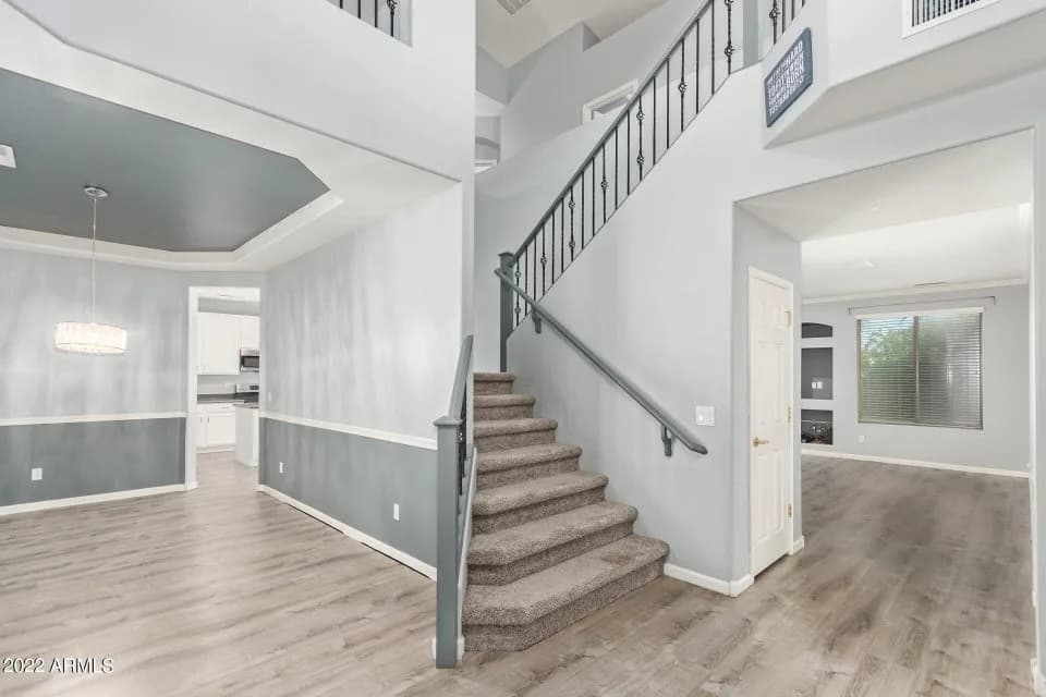 Carpet staircase with 2 tone grey walls 